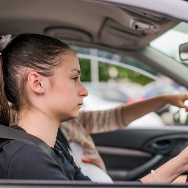 a teenage girl driving the car