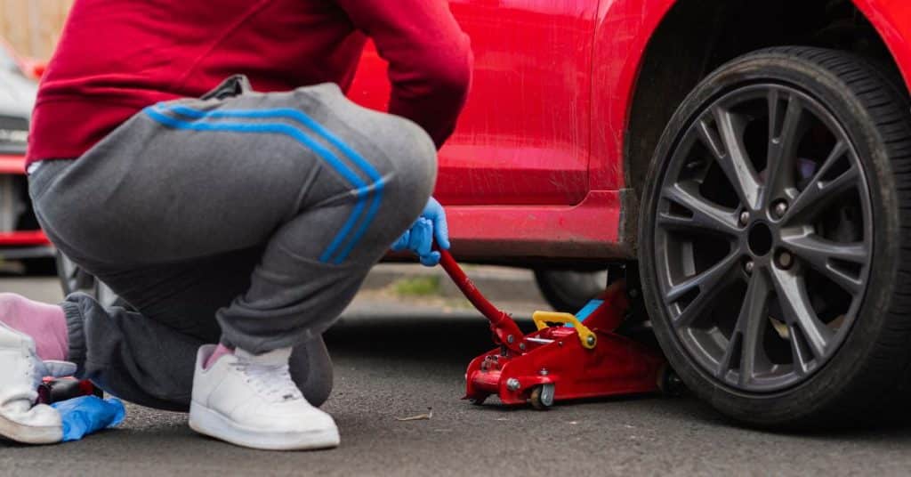 man fixing car tire
